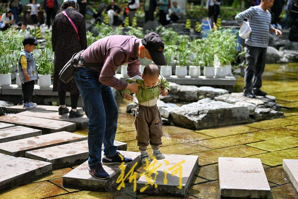 气温飙升春日如夏，市民纷纷到五龙潭泉畔戏水纳凉