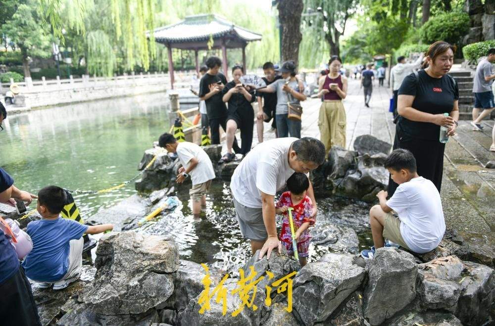护城河畔汇波泉成夏日戏水乐园 泉水漫青石送来天然清凉