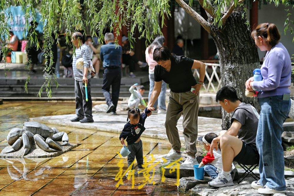 气温飙升春日如夏，市民纷纷到五龙潭泉畔戏水纳凉