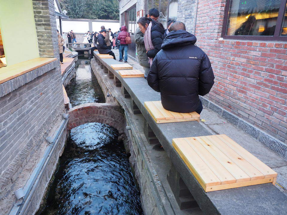 济南明府城泉河边，石栏新设木坐凳让游客听泉